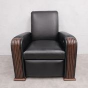 A contemporary black faux leather upholstered electric reclining armchair in the Art Deco style with