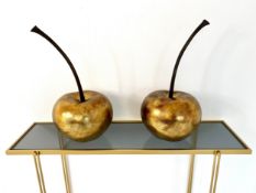 A pair of decorative composite cherries in a gold lacquered finish. H.46cm.