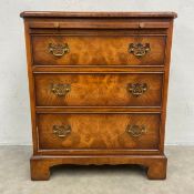 A small 20th century burr elm bachelor's chest in the Georgian style having a quarter veneered top