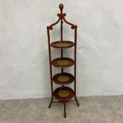 An Edwardian mahogany four tiered cakestand on swept x-stretchered supports. H.116 Diam.25cm.