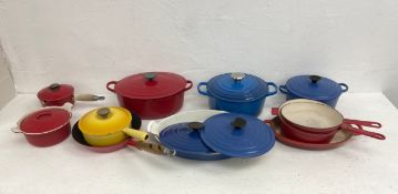 A mixed collection of cast iron Le Creuset pots, pans and oven dishes with impressed makers marks.