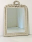 A white painted overmantel mirror in the 19th century French style with laurel leaf cresting above