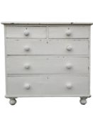 A white painted Victorian pine chest of two short above three long drawers on bun feet. H.94 W.101