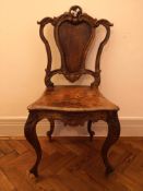 A 19th century style burr walnut hall seat with Rococo carved cresting above panel seat on
