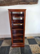 A contemporary lacquered teak revolving quadruple sided bookcase / CD racks with opposing glazed