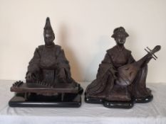A pair of bronze musician figures, seated Japanese Geisha and a male figure playing a koto, on