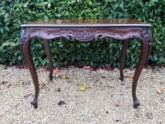 A 19th century style carved hardwood side or centre table raised on slender cabriole supports. H.
