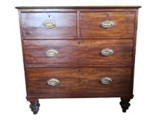 A Georgian mahogany chest of two short above two long drawers on turned bun feet. H.90 W.92 D.51cm.