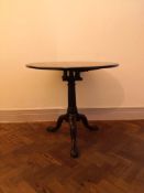 A Georgian, Cuban mahogany occasional table with tilt-top birdcage action on tripod cabriole pad