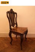A 19th century style burr walnut hall seat with Rococo carved cresting above panel seat on