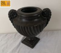 A cast iron campana form urn with coiled rope form handles. H.25cm.