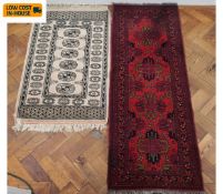 Two small Eastern rugs. 147x54cm. (Largest).