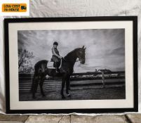 A contemporary large format photographic portrait of a lady on horseback in a glazed frame. H.74.5