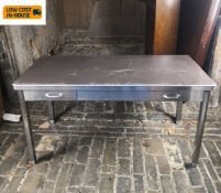 A vintage metal industrial style writing table fitted with two frieze drawers on rounded square