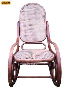 A late 19th century bentwood rocking chair in the Thonet style. H.105cm. (Damage to canework as