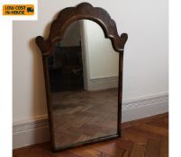 An early Georgian style wall mirror in shaped burr walnut frame. 75x45cm.