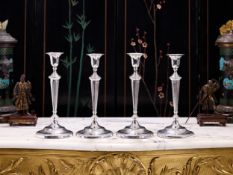 A SET OF FOUR GEORGE III PERIOD STERLING SILVER NEO-CLASSICAL CANDLESTICKS C. 1793