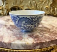 A 19TH CENTURY CHINESE BLUE AND WHITE PORCELAIN DRAGON BOWL