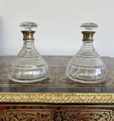 ASPREY: A PAIR OF CUT GLASS AND SILVER GILT MOUNTED DECANTERS