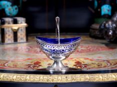 AN EARLY 20TH CENTURY STERLING SILVER AND GLASS SUGAR BASKET, C. 1902