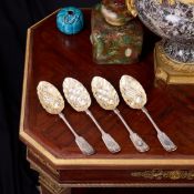 A SET OF FOUR EARLY 20TH CENTURY SILVER AND PARCEL GILT BERRY SPOONS