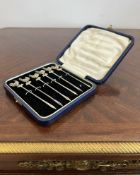 A CASED SET OF EARLY 20TH CENTURY STERLING SILVER COCKTAIL STICKS, C.1902