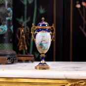 A SMALL EARLY 20TH CENTURY SEVRES STYLE PORCELAIN AND ORMOLU MOUNTED VASE AND COVER