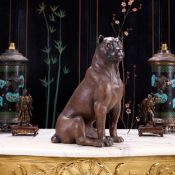 AN EARLY 20TH CENTURY AUSTRIAN PAINTED TERRACOTTA MODEL OF A SEATED PUG