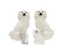 A LARGE PAIR OF STAFFORDSHIRE POTTERY SPANIELS TOGETHER TWO FURTHER