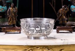 A CHINESE EXPORT SILVER BOWL EMBOSSED WITH DRAGONS