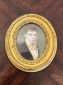 ENGLISH SCHOOL, 19TH CENTURY: A PORTRAIT MINIATURE WITH MOURNING HAIR DESIGN TO REVERSE