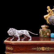 A STERLING SILVER MODEL OF A WALKING LION