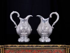 A FINE PAIR OF ANTQUE GERMAN SILVER CLARET JUGS