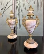 A PAIR OF EARLY 20TH CENTURY MARBLE AND GILT METAL MOUNTED URNS AND COVERS