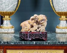 A CHINESE CARVED SOAPSTONE MODEL OF A DOG OF FU AND CUBS