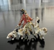 A MINIATURE ANTIQUE COLD PAINTED BRONZE FGIURE OF A HUNTER WITH HOUNDS