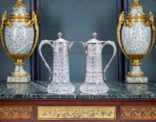 A PAIR OF VICTORIAN STERLING SILVER AND CUT GLASS CLARET JUGS