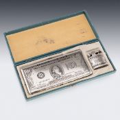 AN AMERICAN SILVER PLATED CIGARETTE CASE AND LIGHTER SHAPED AS A HUNDRED DOLLAR BILL
