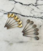 A SET OF TWELVE RUSSIAN SILVER GILT AND ENAMELLED SPOONS