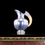 A STERLING SILVER JUG WITH BOAR'S TUSK HANDLE, GERMAN