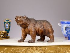 A 19TH CENTURY BLACK FOREST CARVED WOOD MODEL OF A WALKING BEAR