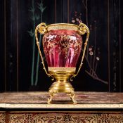 AN ORMOLU MOUNTED AND ENAMELLED CRANBERRY GLASS VASE