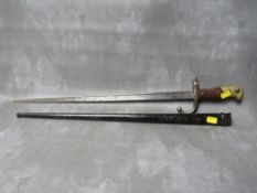 A FRENCH GRAS BAYONET, dated 1879 to spine, with wooden grips, in steel scabbard, L 65.5 cm