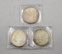(3) Morgan Silver Dollars.