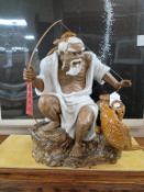 Oriental Large Ceramic Figure Of A Seated Fisherman.