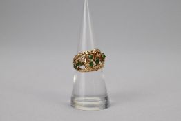 14K Yellow Gold Ring with Green Stones.