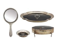 A George V silver tortoiseshell pique ware matched four-piece dressing table set by Mappin & Webb.