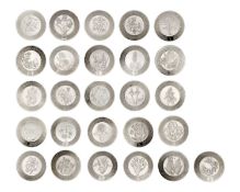 A collection of modern silver miniature alphabet flower plates, on an oak wall rack.