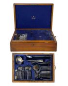 A Mappin & Webb oak cased part canteen of silver-plated cutlery.