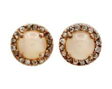 A pair of silver gilt opal and diamond stud earrings.